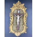 Crucifix in gilt wood frame with fabric backing.Condition ReportArm loose.