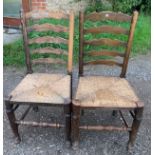 Two oak ladder backed chairs with rush seats. 100cms h.Condition ReportWear to finish. Seat a/f.