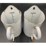 Two vintage 2 litre French marbled enamel wall hanging enema douche jugs. 26cms h.Condition