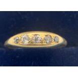 An 18ct gold ring set with 5 diamonds size M, 3gms.Condition ReportWear to setting and shank.