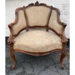 A French walnut and upholstered fauteuil/open armchair in Louis XV style on cabriole legs and scroll