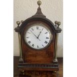 A mahogany and brass mantle clock. Cond: Going. Lacking wood to base and repair to face.