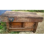 A vintage wooden workbench with cupboards to base at both sides. 153 x 78 x 78cms h with two