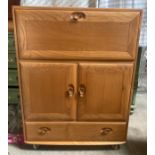 An Ercol drinks cabinet, over 2 cupboard and long drawer. 82 w x 43 d x 110cms h.Condition