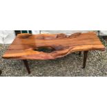 A natural pine coffee table on teak legs. 125cms w x 59cms d x 41cms h.Condition ReportSplits to