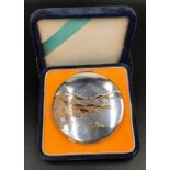 A mirrored compact marked "SILVER" with velvet case and Japanese mountain lake scene of Mount