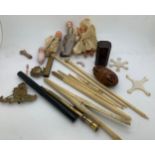 Miscellaneous items to include bone glove stretchers, a Tartan Ware box, cap badges, small dolls,