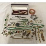 A selection of costume jewellery to include necklaces, pairs of earrings, tie pin brooches