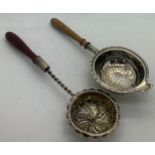 Two wooden handled silver tea strainers, Birmingham 1926 and the other London (marks rubbed) with