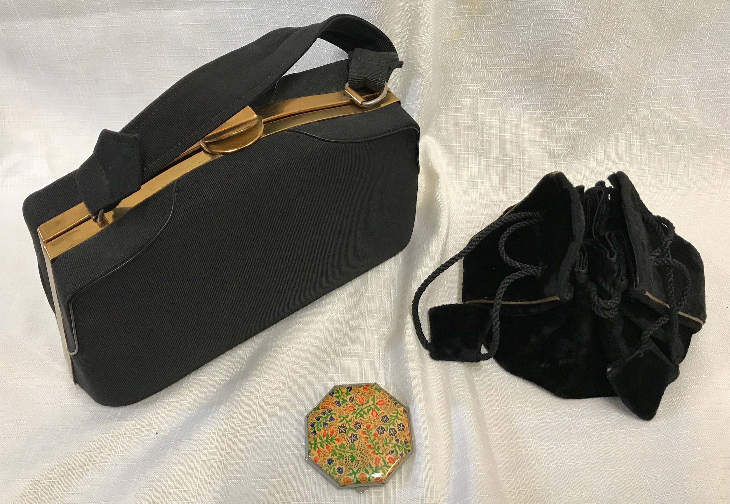A 1950's black clasp handbag 24cmx 15cm, a small black velvet draw string handbag and a 1950's