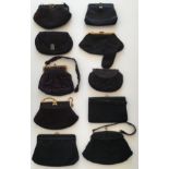 A collection of 8 black fabric handbags with some details to clasps and fronts. Material includes