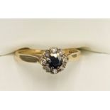 A 9ct gold sapphire and diamond cluster ring. Size N. 2.2gms.Condition ReportGood condition.