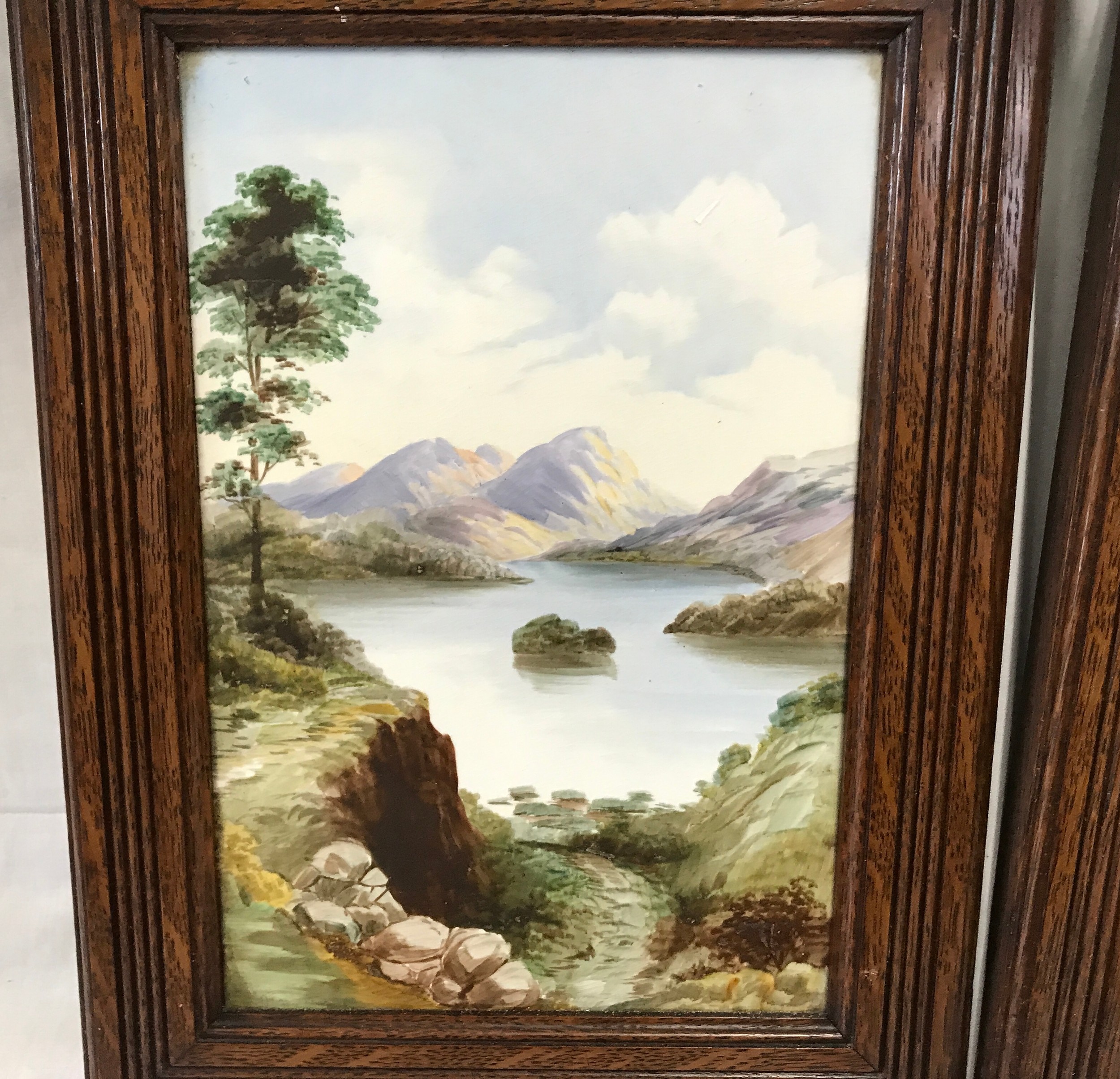 A pair of oak framed hand painted tile plaques of country lake and mountain scenes. Tile size 30. - Image 2 of 4