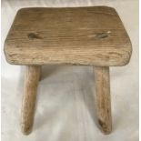 A small oak four legged stool. 20cms w x 17cms x 20.5cms h.Condition ReportSome old worm holes to