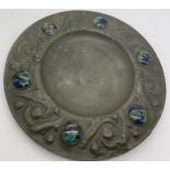 An Arts and Crafts pewter plate with ceramic cabouchons to the border. 15.5cms d.Condition
