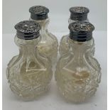 Four silver topped glass pepper pots.Condition ReportSome dents to silver tops.