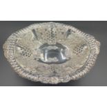 A pierced and embossed silver bowl on a pedestal by Walker and Hall, Birmingham 1902.Condition