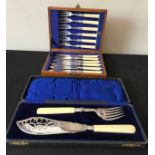 A boxed pair of silver plated fish servers with silver ferrules together with a box of eight EPNS