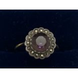 An 18ct gold ring set with amethyst and marcasite size N. 2.6gms.Condition ReportGood condition.