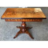 A fine quality Victorian walnut inlaid fold over card table with reeded single pedestal base on four