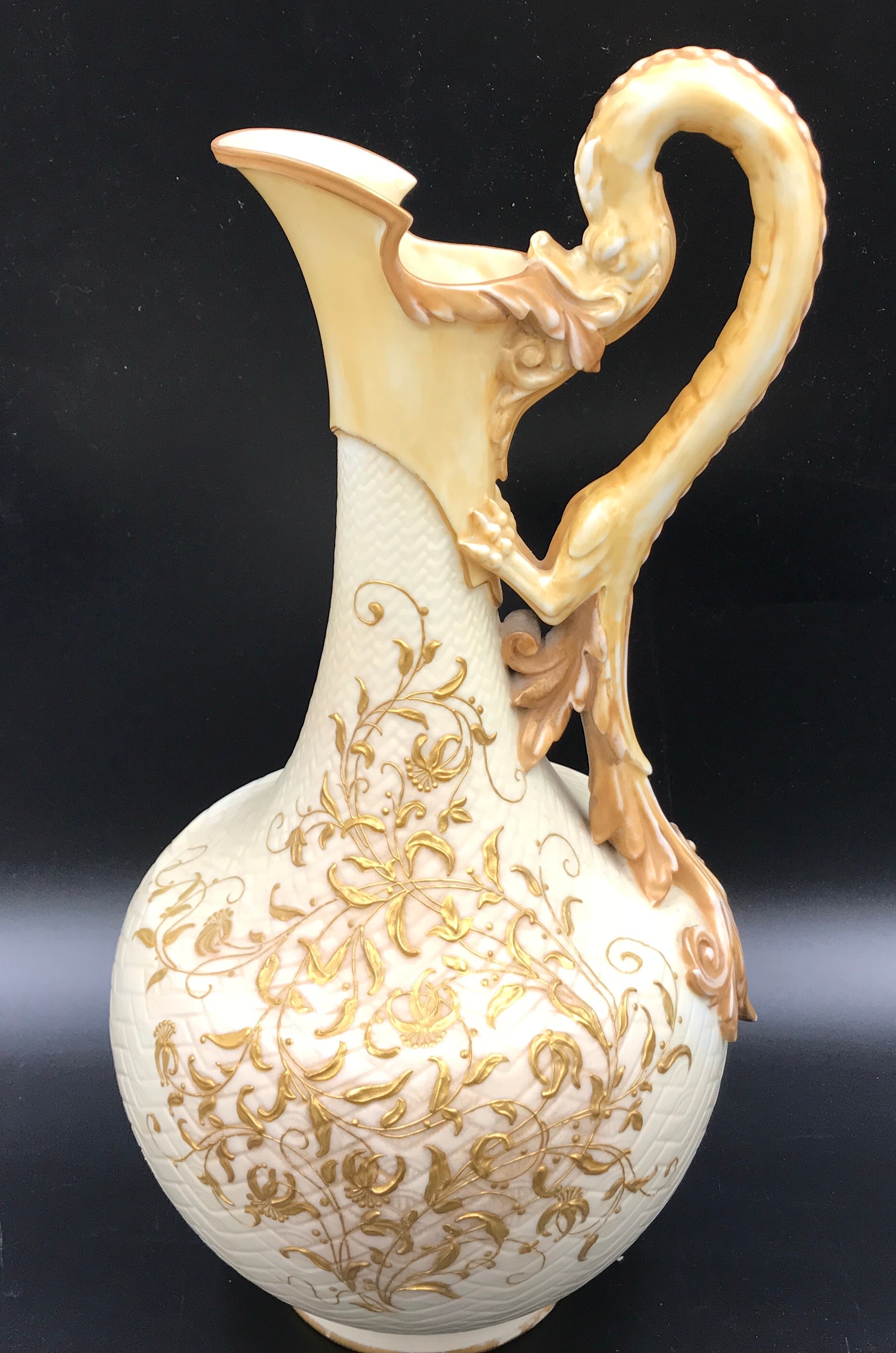 A Royal Worcester dragon handled ewer with gilt floral decoration.Condition ReportGilt rub to base