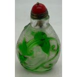 Chinese clear and green glass overlay snuff bottle with dragon decoration. 8cms h.Condition