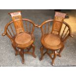 A pair of Chinese armchairs with carved panelled backs and circular wicker seats. Ht to seat