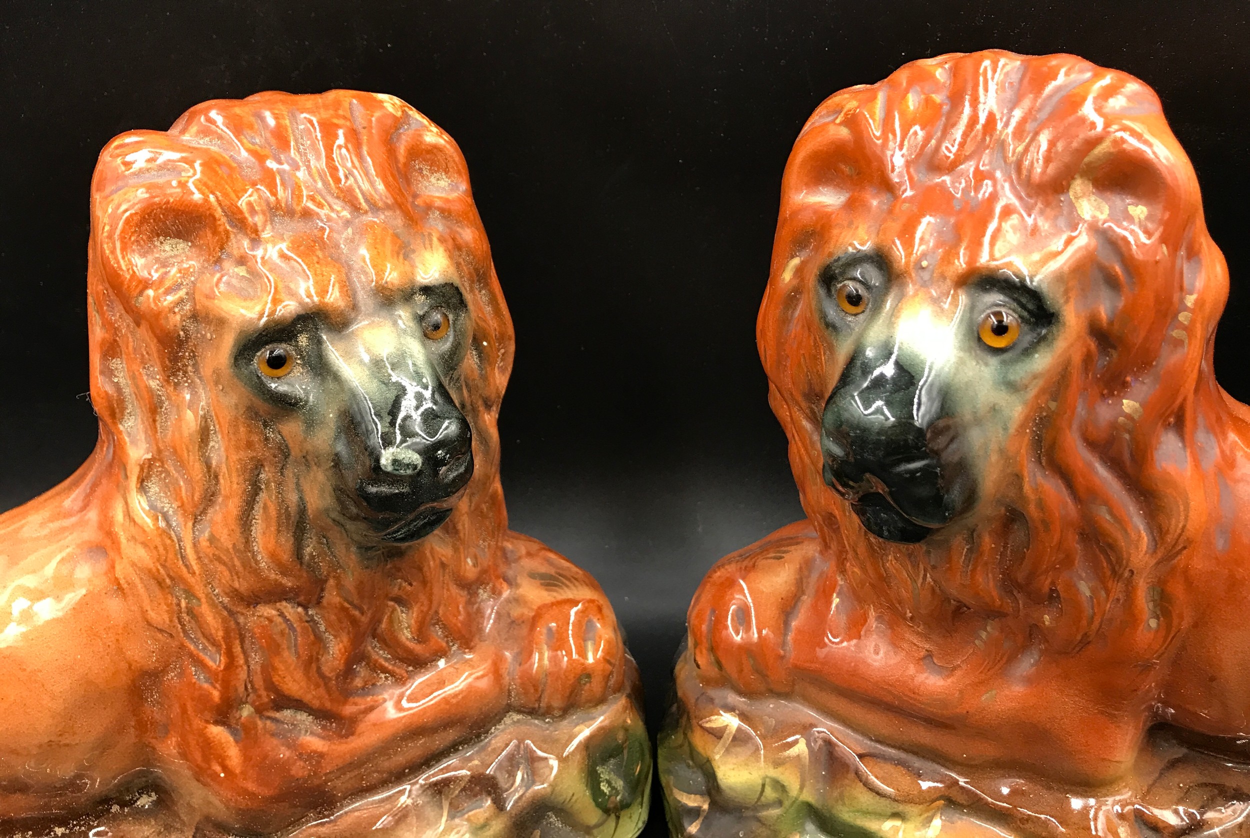 A pair of large Staffordshire pottery lions with glass eyes. 25cms h x 33cms w x14.5cms d. - Image 2 of 4