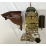 A lantern clock with pulley, weight and wooden corner mounted shelf. A single pointer on a hand