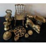 A quantity of brass to include bell and other weights, dog, rocking chair, horse and cart and