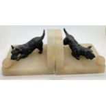A pair of onyx and black Scottie dog book ends.Condition ReportSlight chips to onyx, crack to dogs