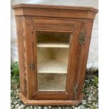 A glazed pine fronted corner cupboard 57cms h x 47cms w. Two shelves to interior.Condition