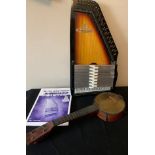 An auto harp with book and a banjo.