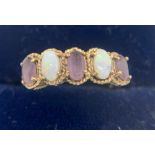 A 9ct gold and opal ring. Size N 2.2gms.Condition ReportGood condition.