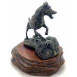 After Edouard Drouot, a bronze dog on wooden stand, dog signed E. Drouot, dog 11.5cms h.Condition