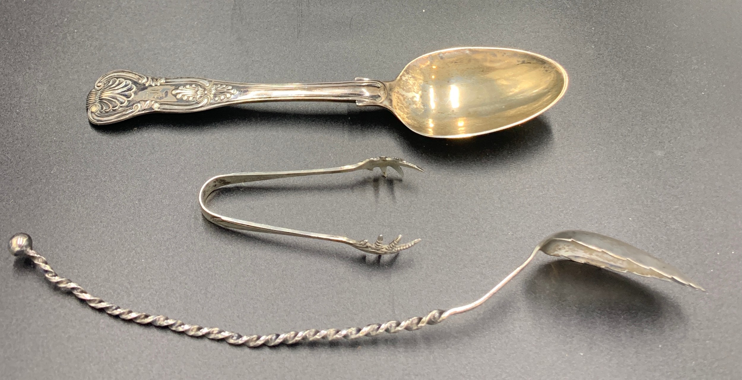 A hallmarked silver spoon London 1854 maker Henry Holland, sugar nips Birmingham 1909 maker I.S.