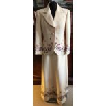 A Stewarts of Harrogate cream wool suit with embroidered floral design to edges, size small,