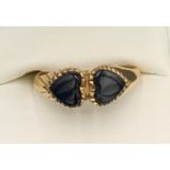 A 9ct gold ring set with two black stone hearts. Size S. 2.7gms.Condition ReportGood condition.