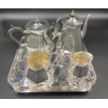 A four piece silver tea service with ebony knop and handles on a tray. Total weight 2720gms,