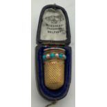 A yellow metal thimble set with seed pearls and turquoise. Tests as 9ct gold in fitted case. 4.