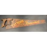 A vintage saw with painted decoration to one side 'Tattoos Removed' 68cms l.Condition ReportGood