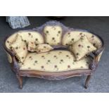 A carved walnut framed two seater sofa, floral upholstered with matching cushions. Height to seat