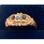 A 9ct gold ring set with white and red stones. Size O/P. 1gm.Condition ReportGood condition.