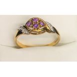 An amethyst and diamond set ring. Size O. 2gms.