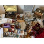 A large quantity of vintage costume jewellery and a leather covered jewellery box.Condition