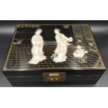 A Japanese black lacquered jewellery box with a mother of pearl lid decorated with Geisha girls