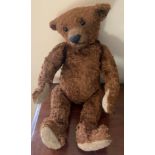 A brown straw filled mohair teddy with long paws and hump back. 35cms l.Condition