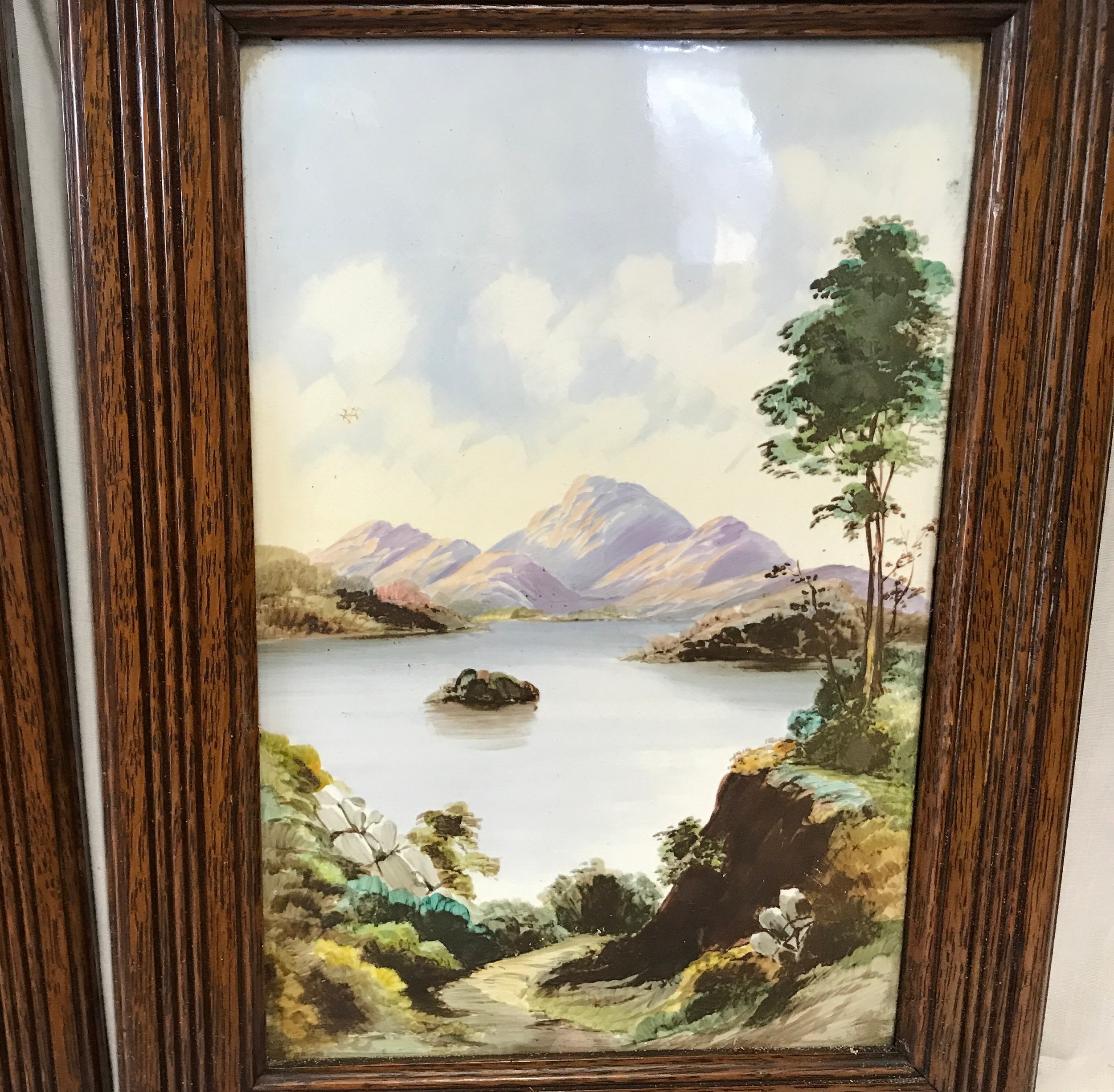 A pair of oak framed hand painted tile plaques of country lake and mountain scenes. Tile size 30. - Image 3 of 4