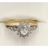 A 9ct gold aquamarine and diamond cluster ring, size P. 2.5gms.