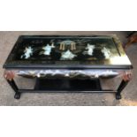 A Japanese black lacquer coffee table with undershelf and painted and mother of pearl inlaid